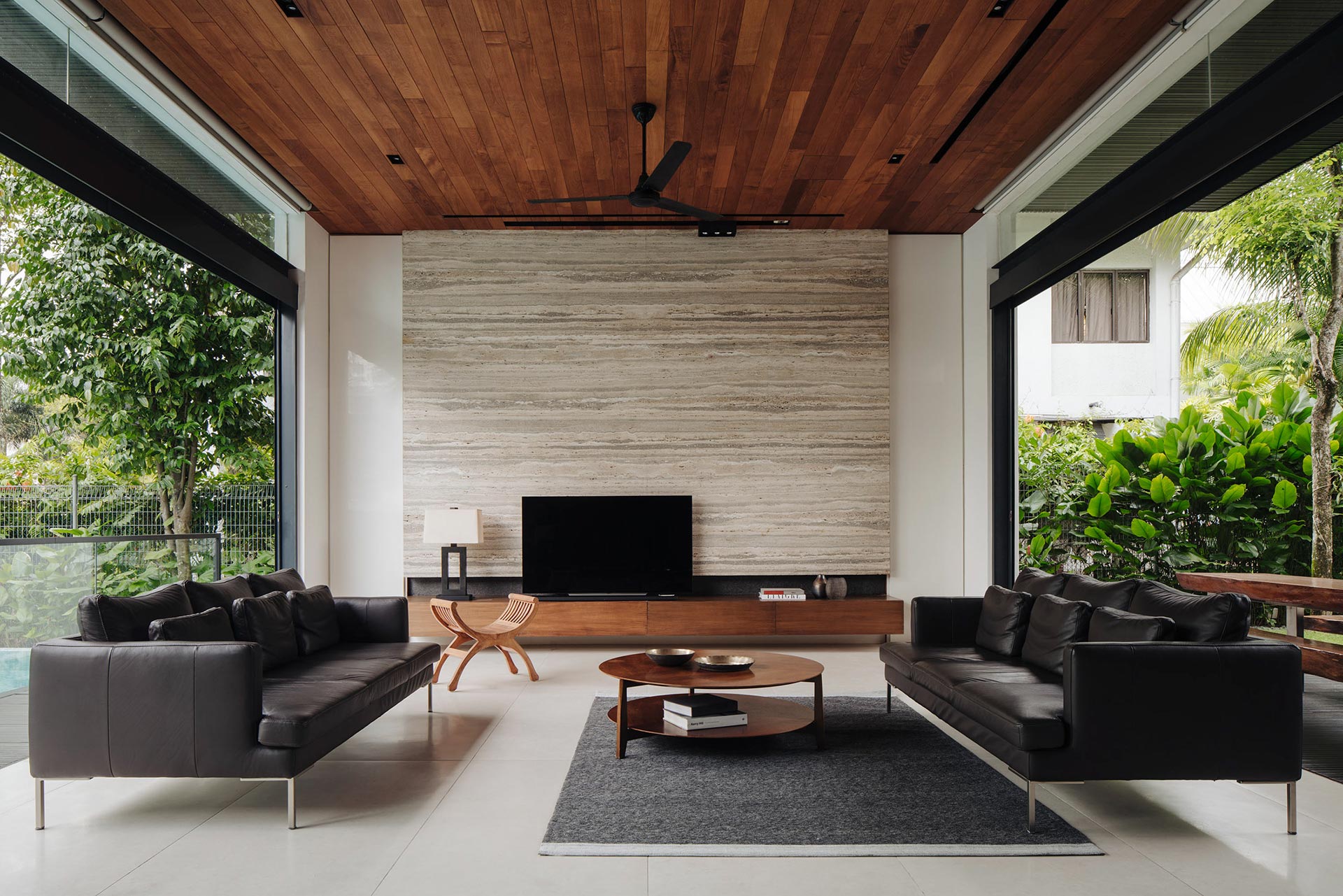 Modern living room design, with leather sofa set and a TV unit in a Delhi home